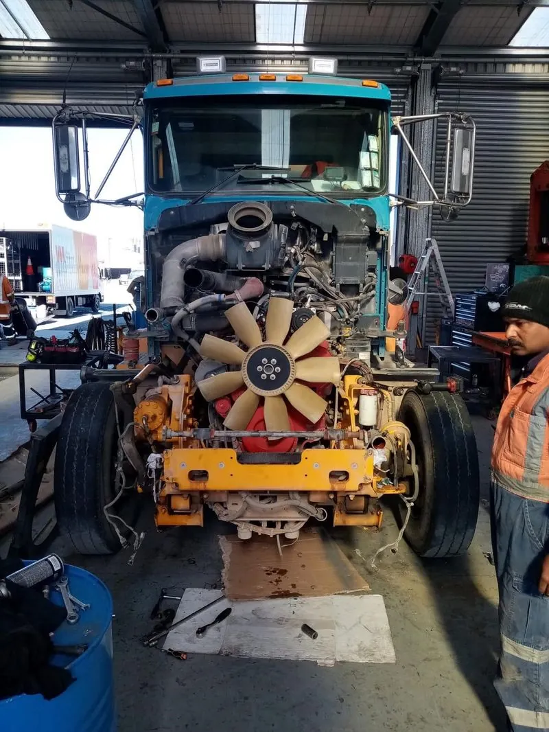 Workshop exterior with Mulch Man truck and Ford Ranger